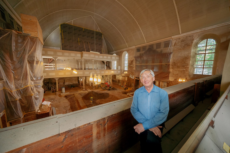 Das Bild zeigt Rainer Schulze und die Baustelle im Innenraum der Kirche. 