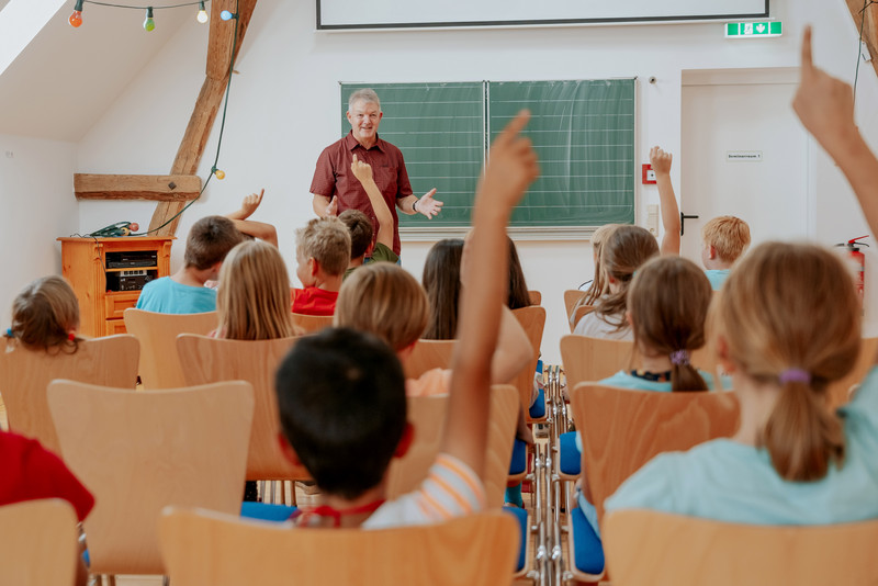 Das Bild zeigt Ulrich Weimeister vor einer Jugendgruppe in einem neuen Seminarraum.